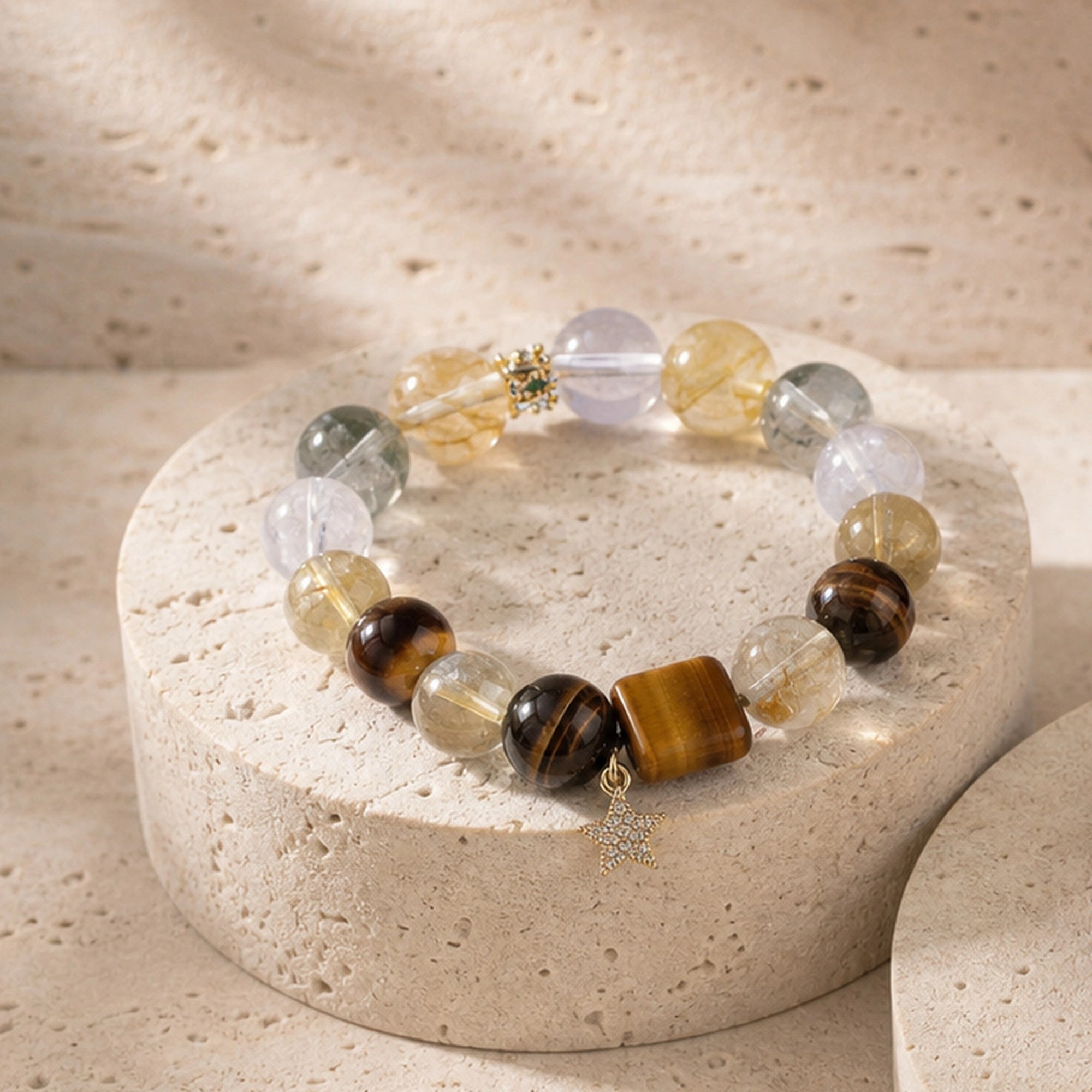 Gemstone beaded bracelet with clear and amber stones, dark tiger-eye beads, gold charm