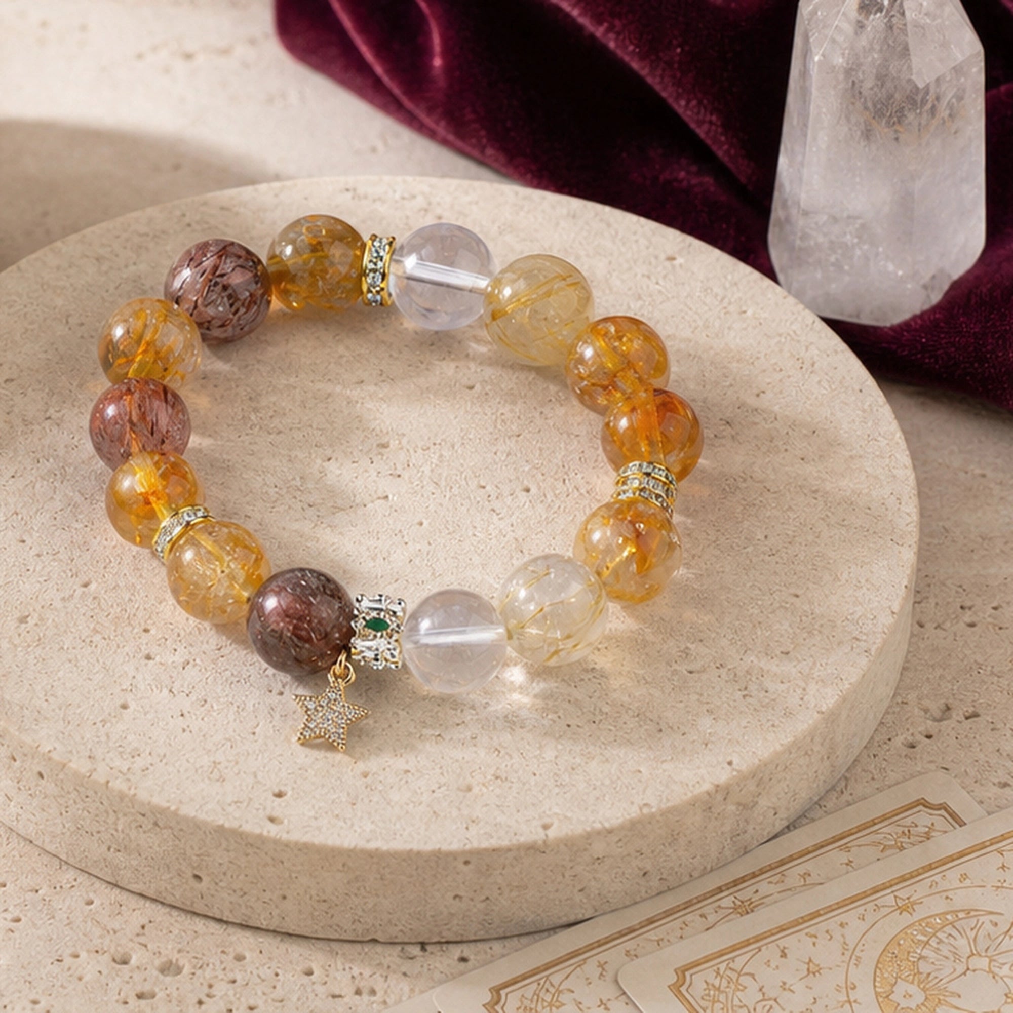 Gemstone beaded bracelet with amber and smoky stones, clear beads, gold star-cross charms