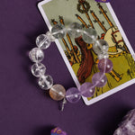 Amethyst and clear crystal bead bracelet with gold accent and silver cross charm