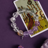 Amethyst and clear crystal bead bracelet with gold accent and silver cross charm
