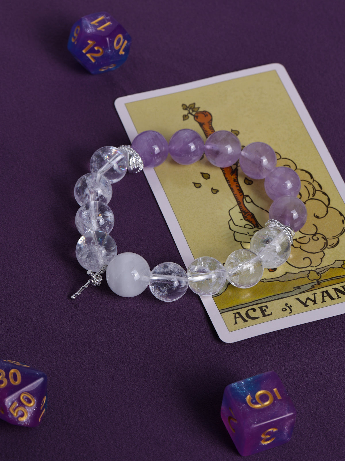 Lilac and clear gemstone-style bead bracelet with cross charm, elastic string.