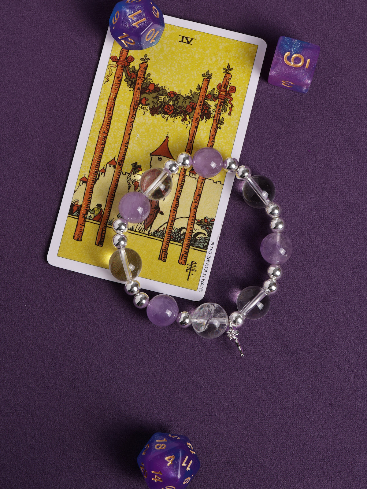 Purple and clear bead bracelet with silver spacers and small cross charm