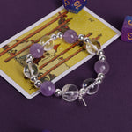 Purple and clear crystal bead bracelet with silver beads and cross charm