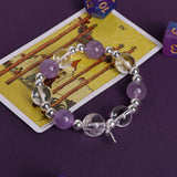 Purple and clear crystal bead bracelet with silver beads and cross charm