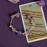 Beaded bracelet with lavender stones, clear beads, and silver-tone chain links