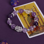 Purple and clear crystal bead bracelet with silver-tone spacers and small charm