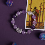 Purple crystal bead bracelet with silver-tone spacers and clear faceted center bead
