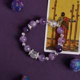 Purple crystal bead bracelet with silver-tone spacers and clear faceted center bead