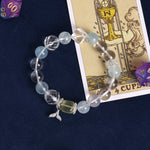 Light blue and clear beaded charm bracelet with fish and starfish pendants
