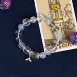 Light blue and clear beaded charm bracelet with fish and starfish pendants