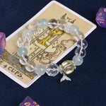 Light blue and clear beaded charm bracelet, featuring starfish and fish pendants