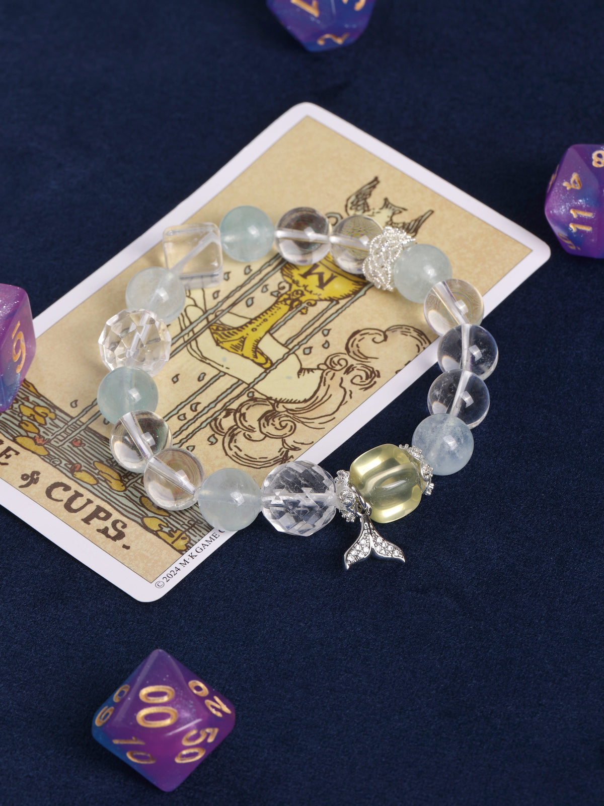 Light blue and clear beaded charm bracelet, featuring starfish and fish pendants