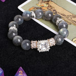 Gray beaded stretch bracelet with large square crystal center and sparkling side details