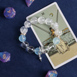 Clear and light blue bead bracelet with gold separators and two dangling charms