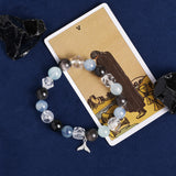 Beaded energy bracelet with mixed light-blue and black stones, crystal spacers, angel charm