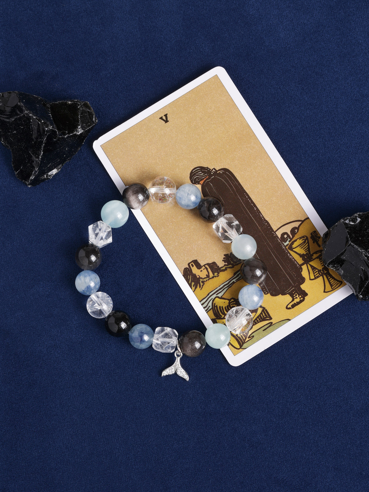 Beaded energy bracelet with mixed light-blue and black stones, crystal spacers, angel charm