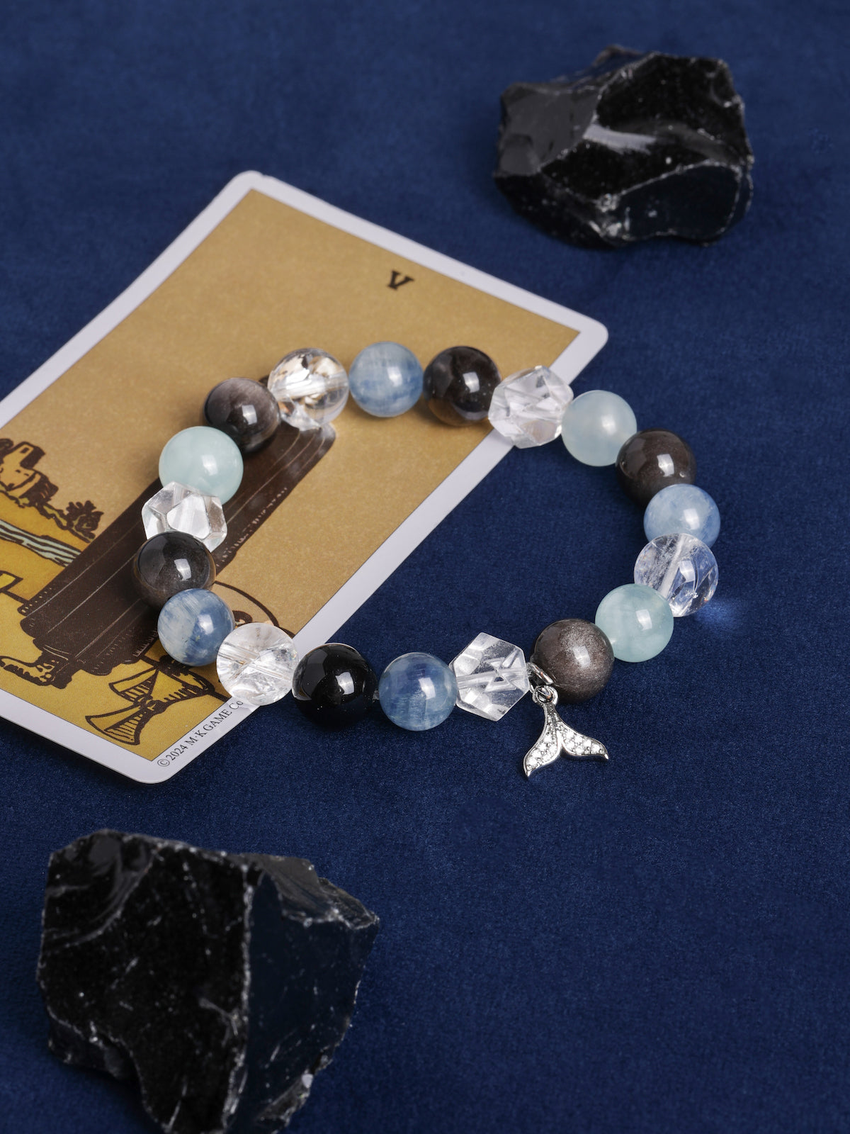 Beaded energy bracelet with blue and dark stones, clear crystal blocks, dangling angel charm