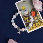Pastel beaded bracelet with dolphin charm and rose, blue, and gray beads