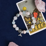 Pastel beaded bracelet with dolphin charm and rose, blue, and gray beads