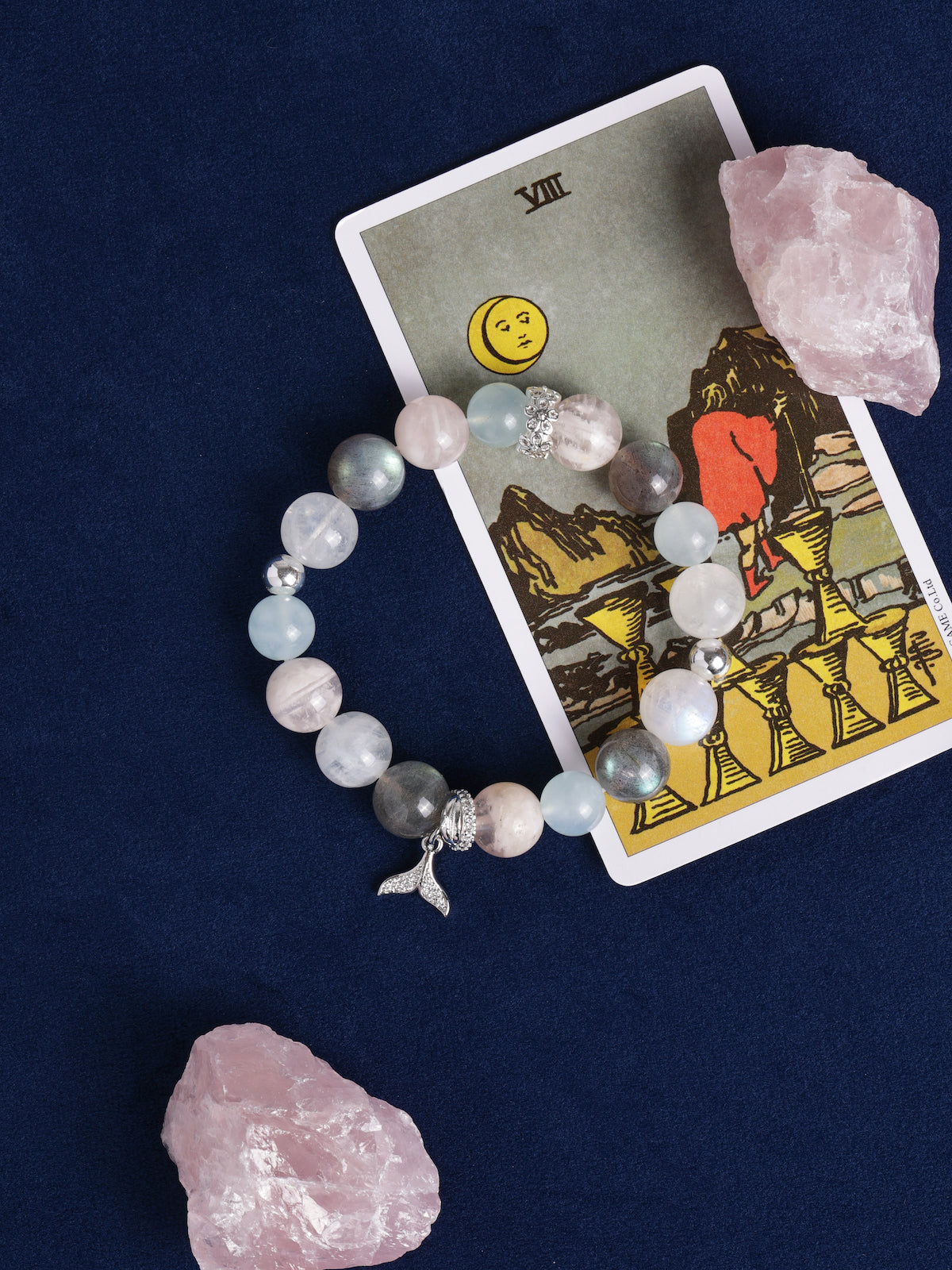 Pastel beaded bracelet with dolphin charm and rose, blue, and gray beads