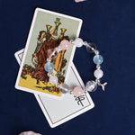 Crystal bead charm bracelet with silver accents, pink and light blue beads