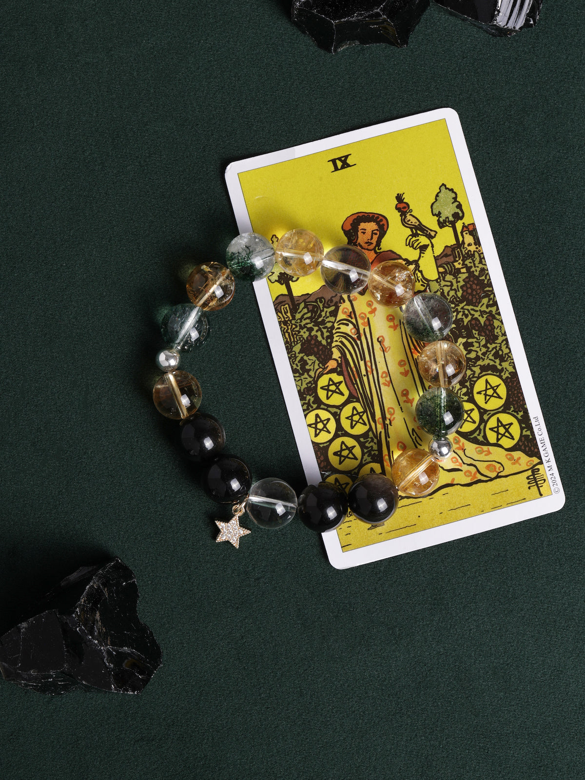Beaded bracelet with clear and golden stones, black beads, and a dangling star charm