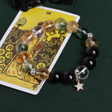 Beaded bracelet with smoky clear, golden, and black beads plus a star charm