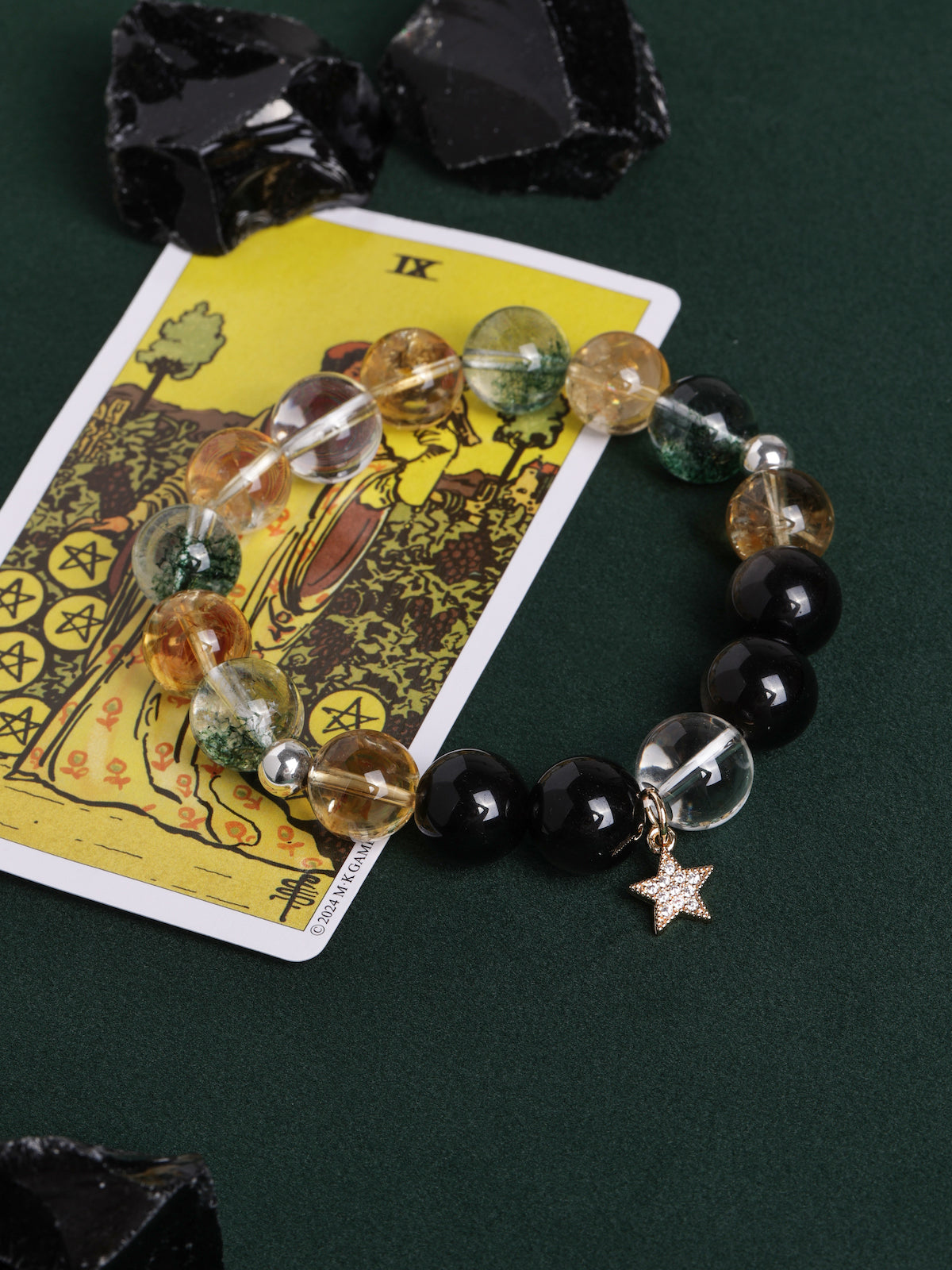 Beaded bracelet with smoky clear, golden, and black beads plus a star charm