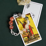 Beaded bracelet with gray, white, clear, and orange stones and silver infinity-style clasp