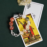 Beaded bracelet with gray, white, clear, and orange stones and silver infinity-style clasp