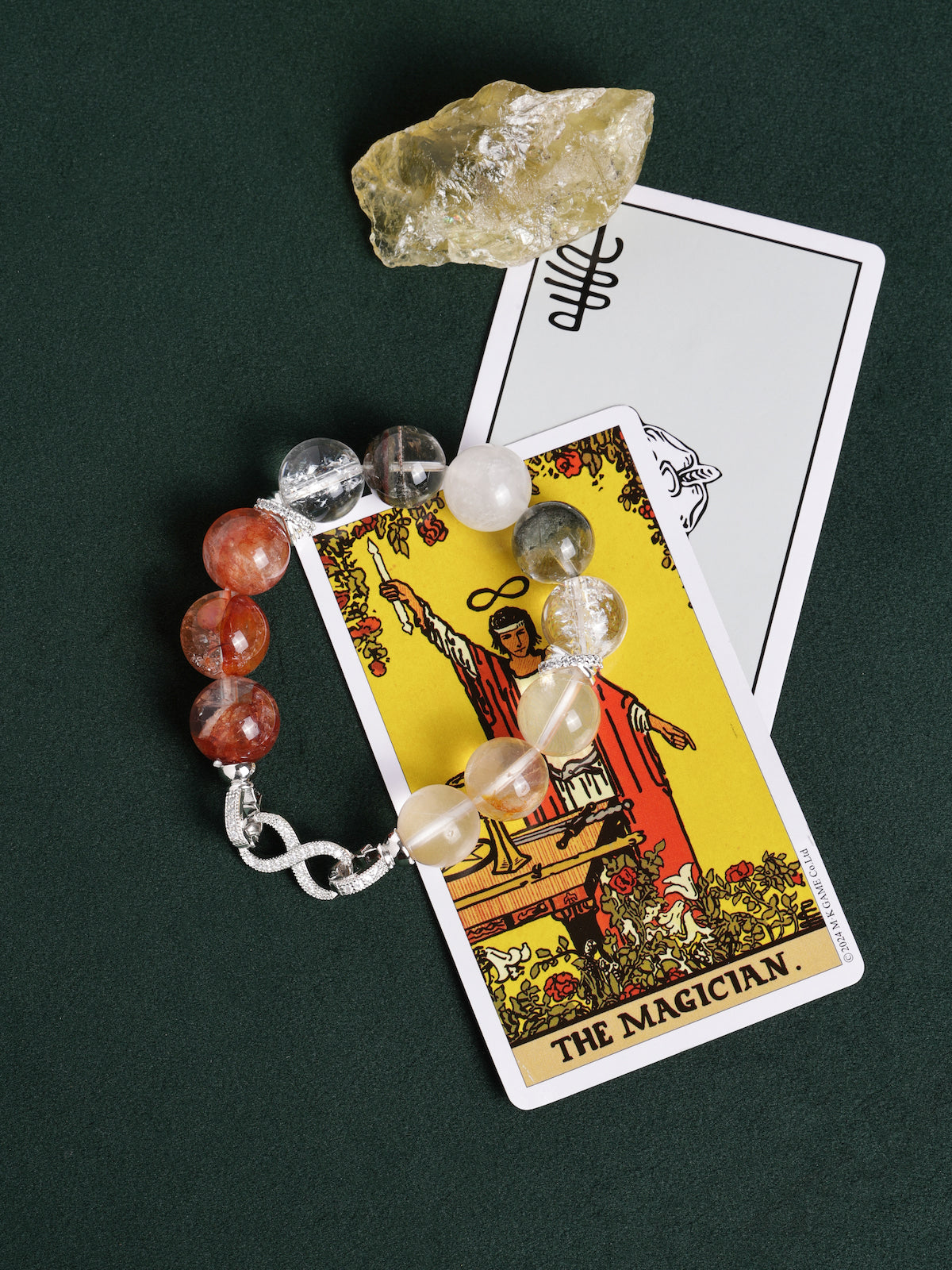 Beaded bracelet with gray, white, clear, and orange stones and silver infinity-style clasp