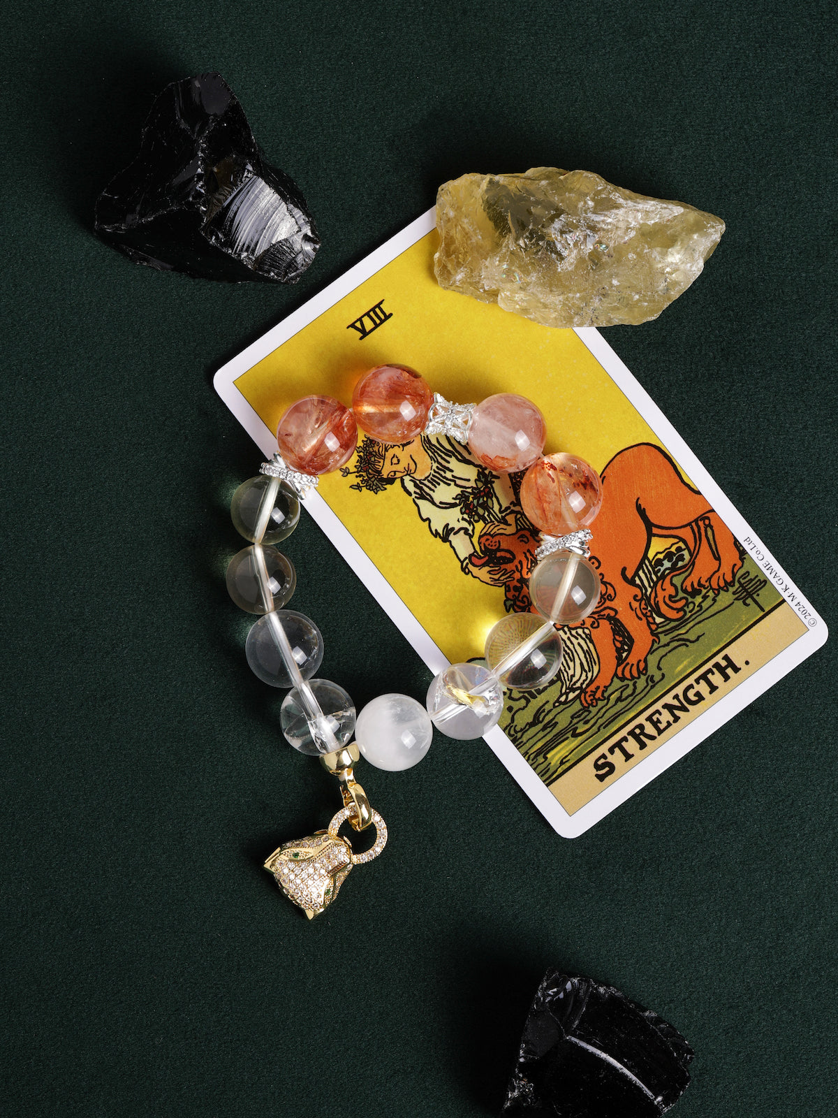 Beaded bracelet with orange-red and clear beads, silver accents, and gold heart charm