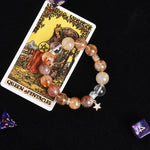 Beaded bracelet with mixed amber and brown stones and star pendant charm