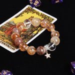 Beaded bracelet with amber, gold, and smoky stones plus star charm and crystal spacer