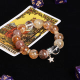 Beaded bracelet with amber, gold, and smoky stones plus star charm and crystal spacer