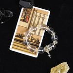 Clear quartz bead energy bracelet with gold-tone spacers and star charm