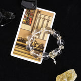 Clear quartz bead energy bracelet with gold-tone spacers and star charm