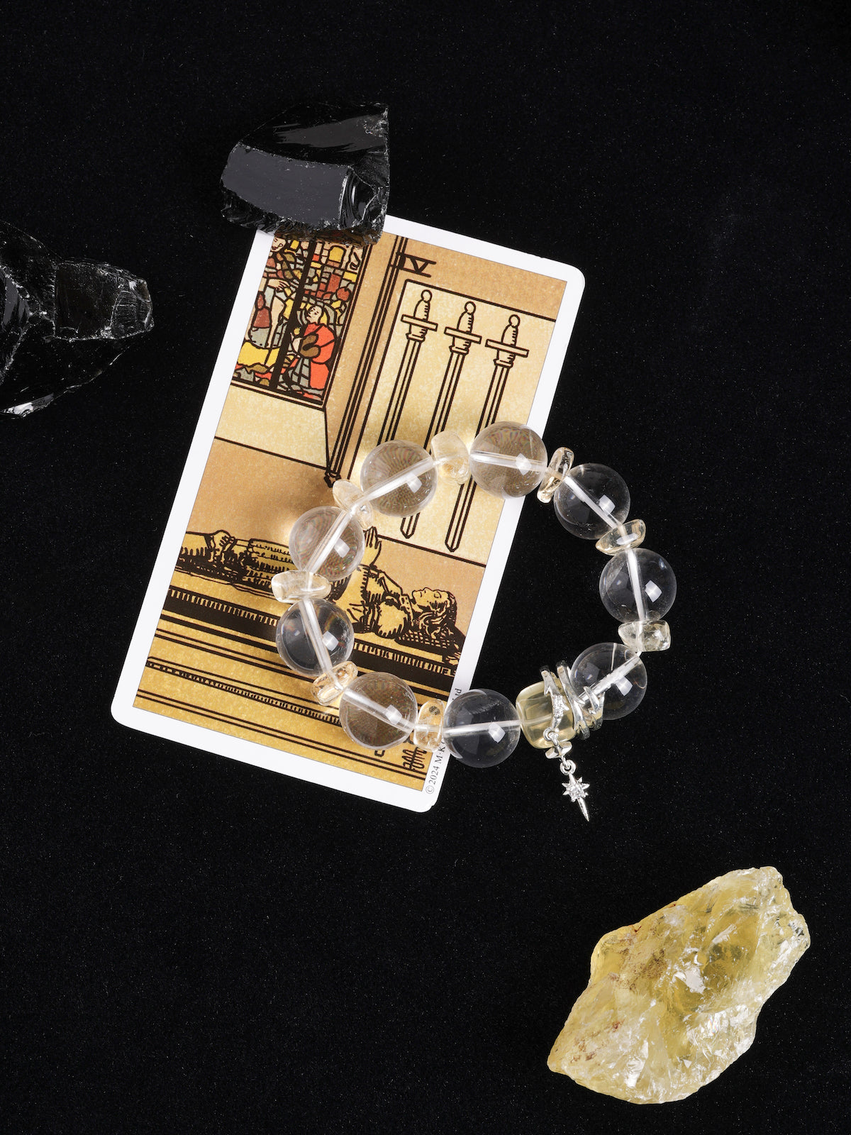 Clear quartz bead energy bracelet with gold-tone spacers and star charm