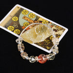 Beaded bracelet with faceted clear beads and dark red round center bead, silver accents