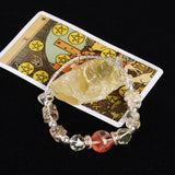 Beaded bracelet with faceted clear beads and dark red round center bead, silver accents