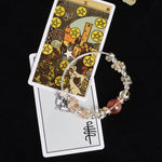 Beaded bracelet with mixed clear, pale yellow, and dark red stones, silver bead spacers