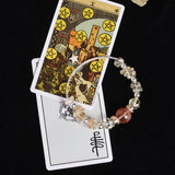 Beaded bracelet with mixed clear, pale yellow, and dark red stones, silver bead spacers