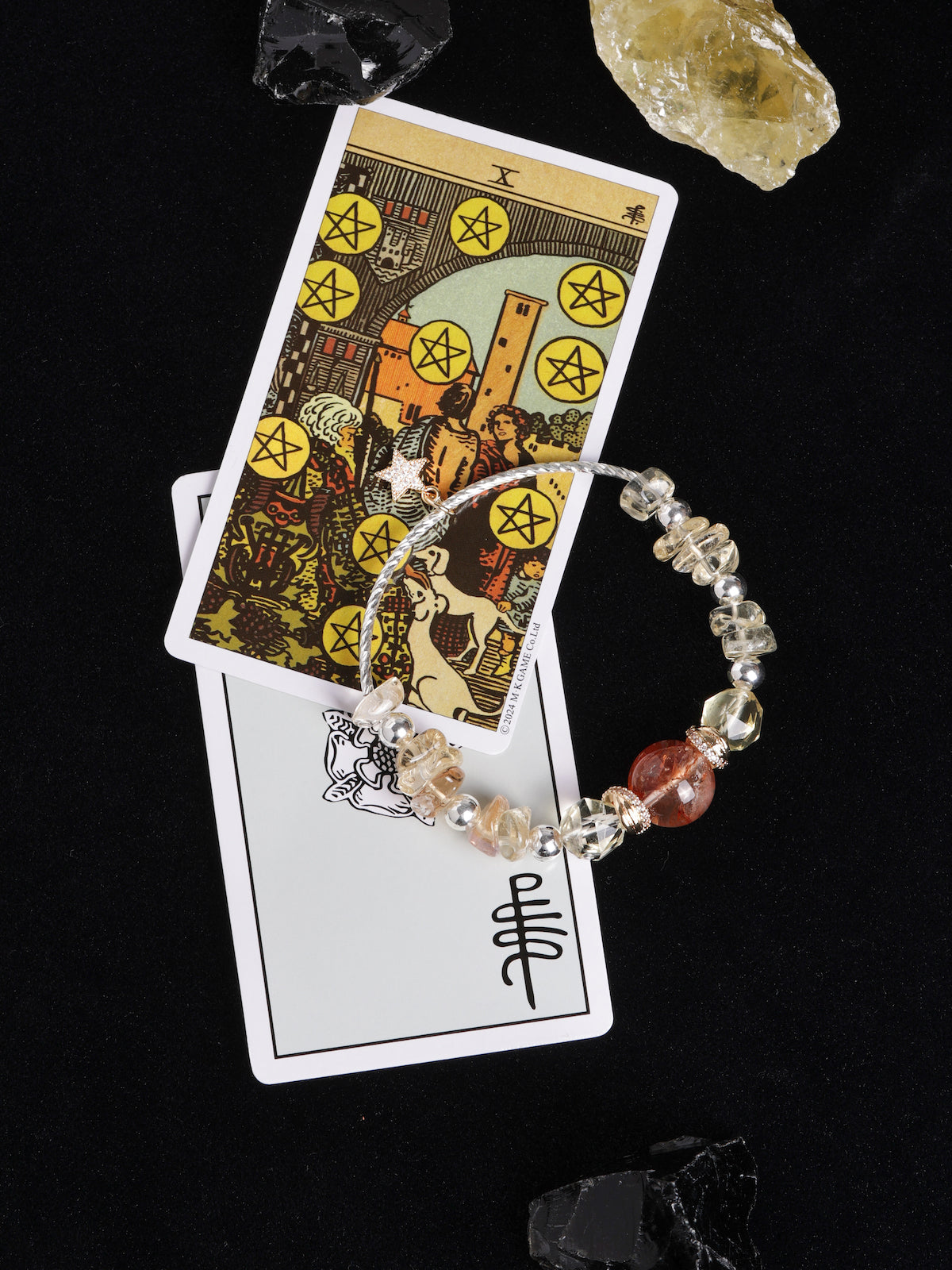 Beaded bracelet with mixed clear, pale yellow, and dark red stones, silver bead spacers