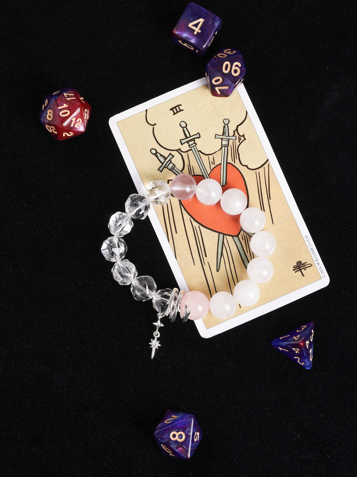 Crystal and bead bracelet with white, pink, and clear stones; silver star cross charm.