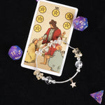Energy bracelet with silver chain, clear gemlike beads, and star charm