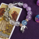 Beaded bracelet with clear, lilac, light-blue stones and gold-toned angel charm