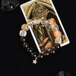 Beaded energy bracelet with translucent and dark round beads, plus hanging gold star charm