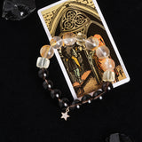 Beaded energy bracelet with translucent and dark round beads, plus hanging gold star charm