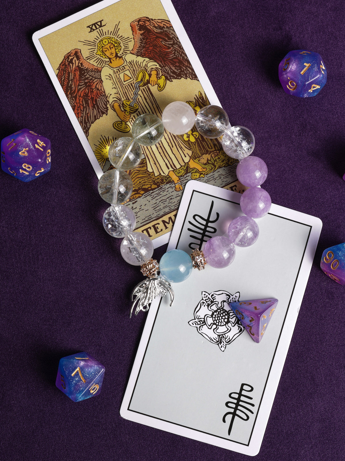 Beaded energy bracelet with lilac and clear beads, blue accent, and angel charm