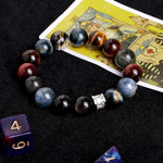 Gemstone bead bracelet featuring dark blue, amber, and red tones with silver clasp detail